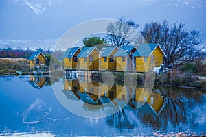 House reflected in lake near mountain