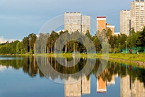 House reflected in lake at sunset light in Zelenograd district of Moscow, Russia