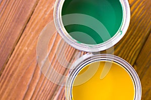 House renovation concept, colorfull paint cans on dark wooden background