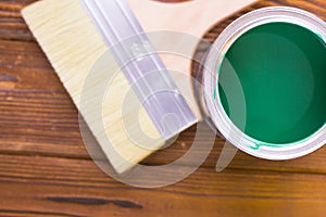 House renovation concept, colorfull paint cans and paintbrushes on dark wooden background