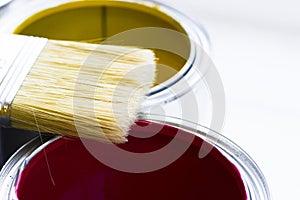 House renovation concept, colorfull paint cans and paintbrushes on wooden background