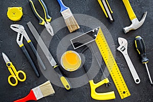 House renovation with implements set for building, painting and repair black table background top view pattern