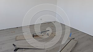 House renovation: installing laminate flooring in a renovated room with white walls