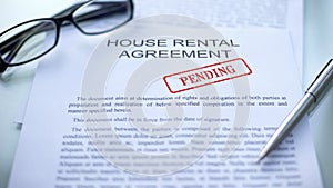 House rental agreement pending, seal stamped on official document, business