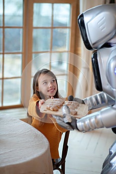 House robot in apron going to serve the table for dinner