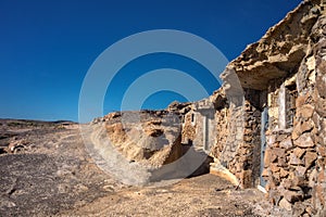 House in the rock on the background of blue sky. Secret housing.