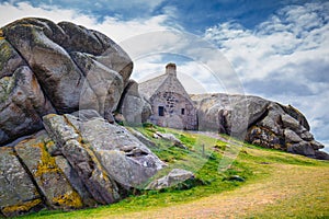 House between the rocks in Meneham village, Kerlouan, Finistere, Brittany (Bretagne), France