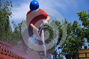 House roof cleaning with pressure tool