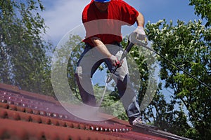 House roof cleaning with pressure tool