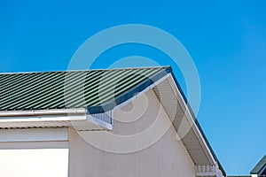 House roof with gutters and drainpipes