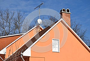 House roof with smoke stack and antennas