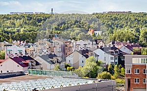 House roof top modern residential settings mixed-use urban multi-family residential district area forest background.