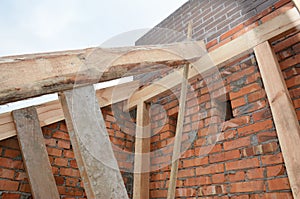 House roof wooden frame construction with trusses, wooden beams