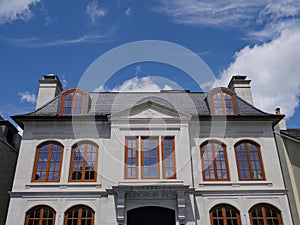 House with round topped brown casement windows photo