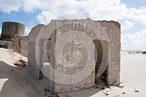 House in ruins in the dunes whit blue sky and cloudss