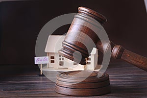 House for sale, auction hammer , symbol of authority and Miniature house . Courtroom concept.