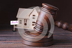 House for sale, auction hammer , symbol of authority and Miniature house . Courtroom concept.