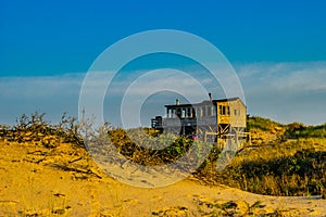 House among sand Dunes and Grass of the Provincelands Cape Cod MA US.