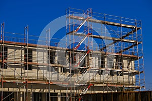 house in scaffolding.Building materials and the process of building a new house.Home construction.Construction of real