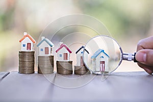 House searching concept with a magnifying glass, house and money. magnifying glass and coins. concept of mortgage, construction,