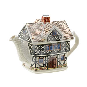 House shaped teapot on white background with clipping path