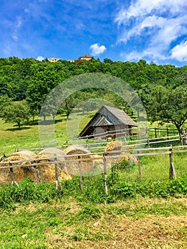 House about sheep and hay, behind ruin of Tochnik Castle. Old stronghold, Czech