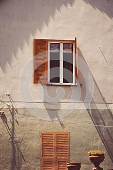 House with shutters in Provence of Italy. Typically Italian windows