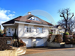 House for single family in white with special cross roof and dormer