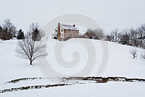 House on a snow covered hill, in a rural area of Carroll County, Maryland. photo