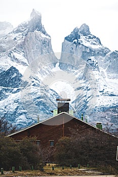 House and snowy mountains in Torres del Paine National Park