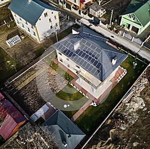 House with solar panel system on rooftop in new neighborhood.