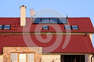 House with solar panels on the roof for water heating