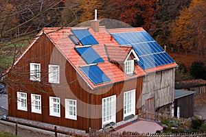 House with solar panels sun heating system on roof