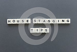 House staging tips word made of square letter word on grey background. photo