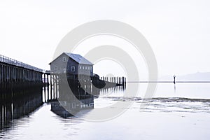 House on stilts at edge of pier at plant on Pacific coast soothi