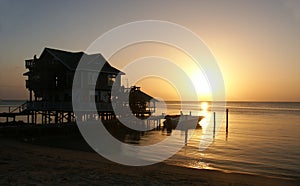 House with sunset on the seashore