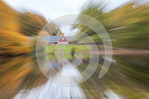 The house is surrounded by an autumn forest, standing on the shore of a lake. photographed with different effects of motion and