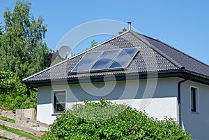 House with tiled roof and solar thermal power plant