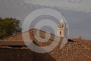 House and tower of the church. Bello. photo