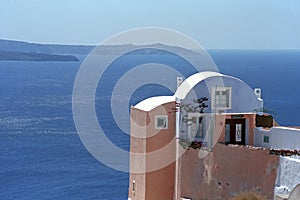 House in traditional Cycladic architectural style, on the edge of the volcano caldera of Santorini island.