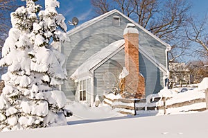 House and tree in winter snow