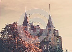 house with two towers, towers with spires, house in autumn