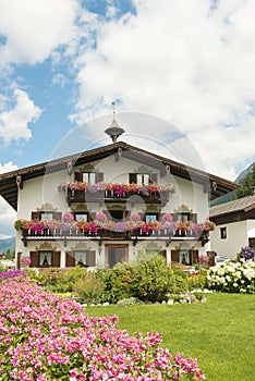 House in Tyrol with beautiful flowers on balcony