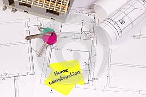 House under construction, home keys and electrical diagrams or blueprints, building home concept