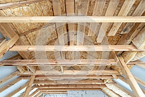 House under construction with insulation glass wool on an attic floor