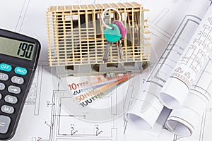 House under construction, keys, calculator, currencies euro and electrical drawings, concept of building home