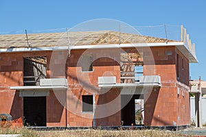 house under construction with safety net around the roof