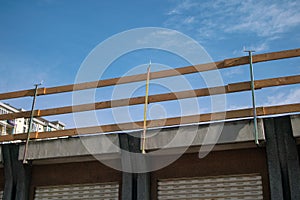 House under renovation with railing for construction site on the facade