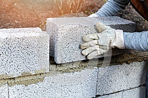 House wall construction - mason laying expanded clay blocks photo