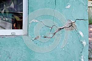 House wall with a crack, destroying the house